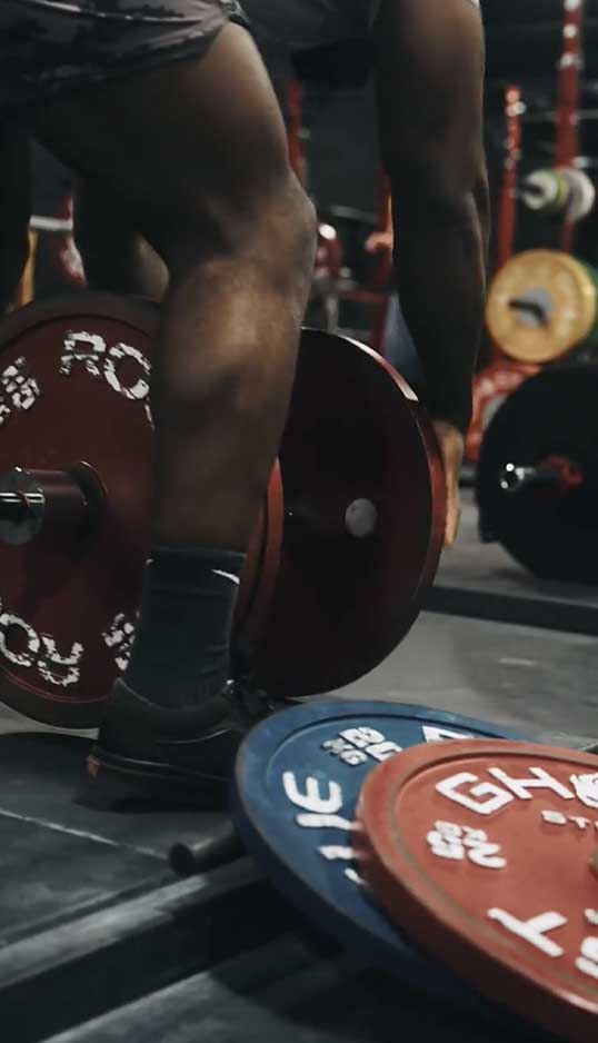 coach in the gym by weights